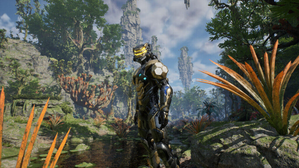 Armored EV2 warrior exploring a lush alien jungle with towering rock pillars